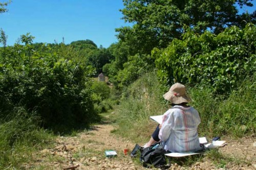 artists painting in the countryside on a path