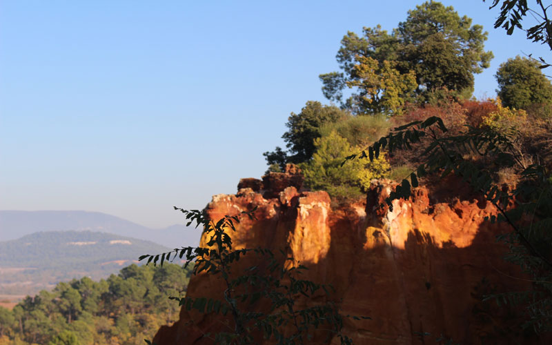 red cliffs ocre blue luberon hills